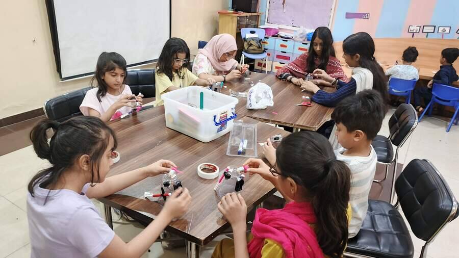 Group of school students building electronics projects during a STEMForge hands-on workshop