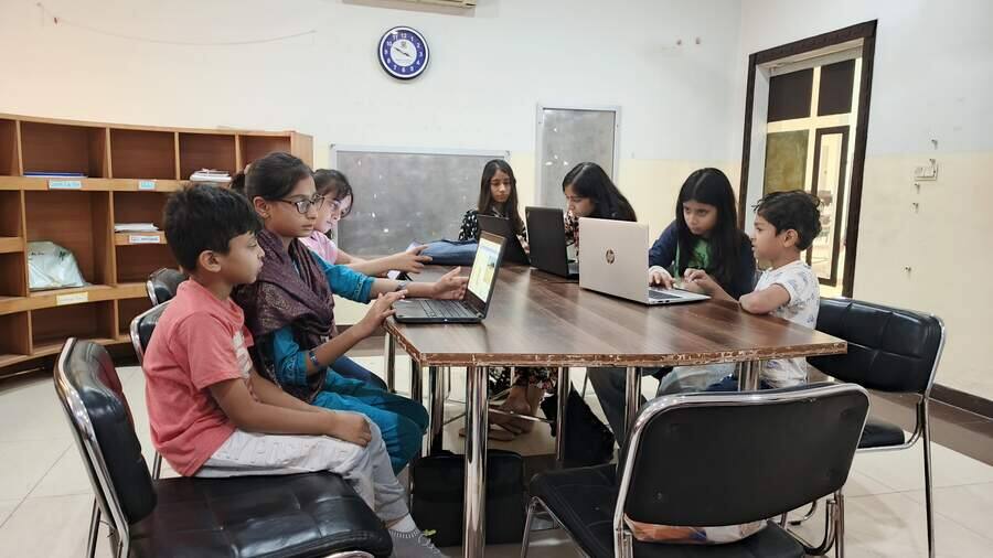 School students learning to code on laptops in a STEMForge programming workshop