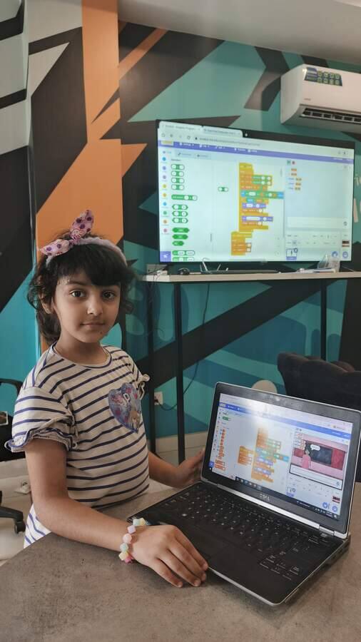 Young student building her first program at a STEMForge coding session in Lahore