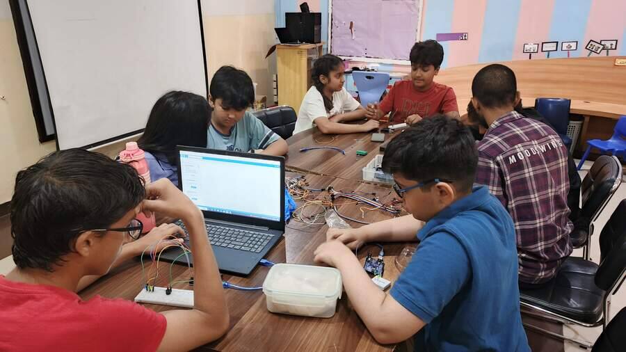 Students wiring Arduino circuits during a STEMForge electronics workshop at school