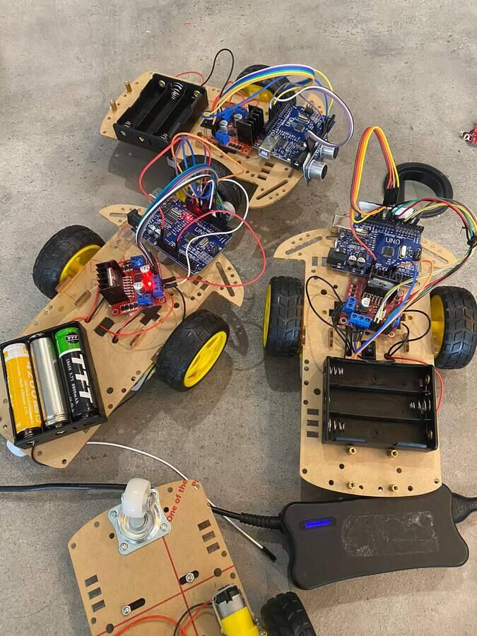 Three Arduino robot cars with ultrasonic sensors built by students at STEMForge workshops