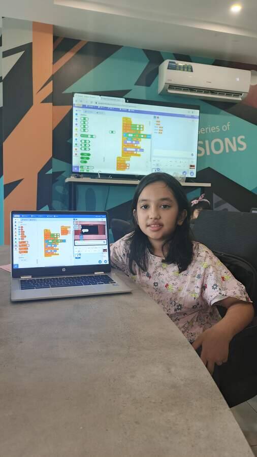 Student building an interactive game during a STEMForge coding workshop